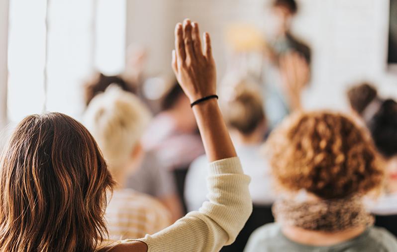 image of woman with raised hand